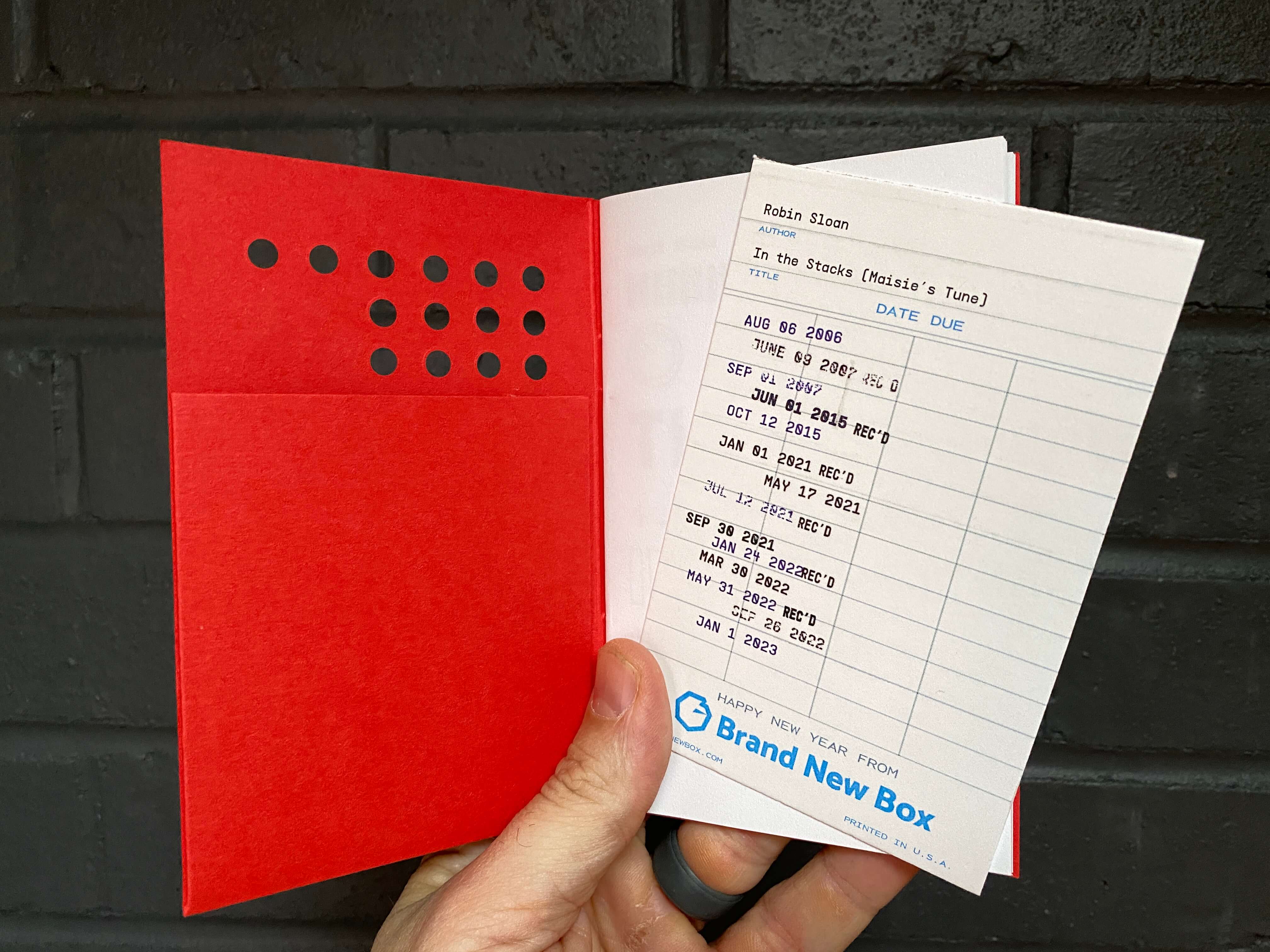 Tucked into each book was a 'library checkout' card.